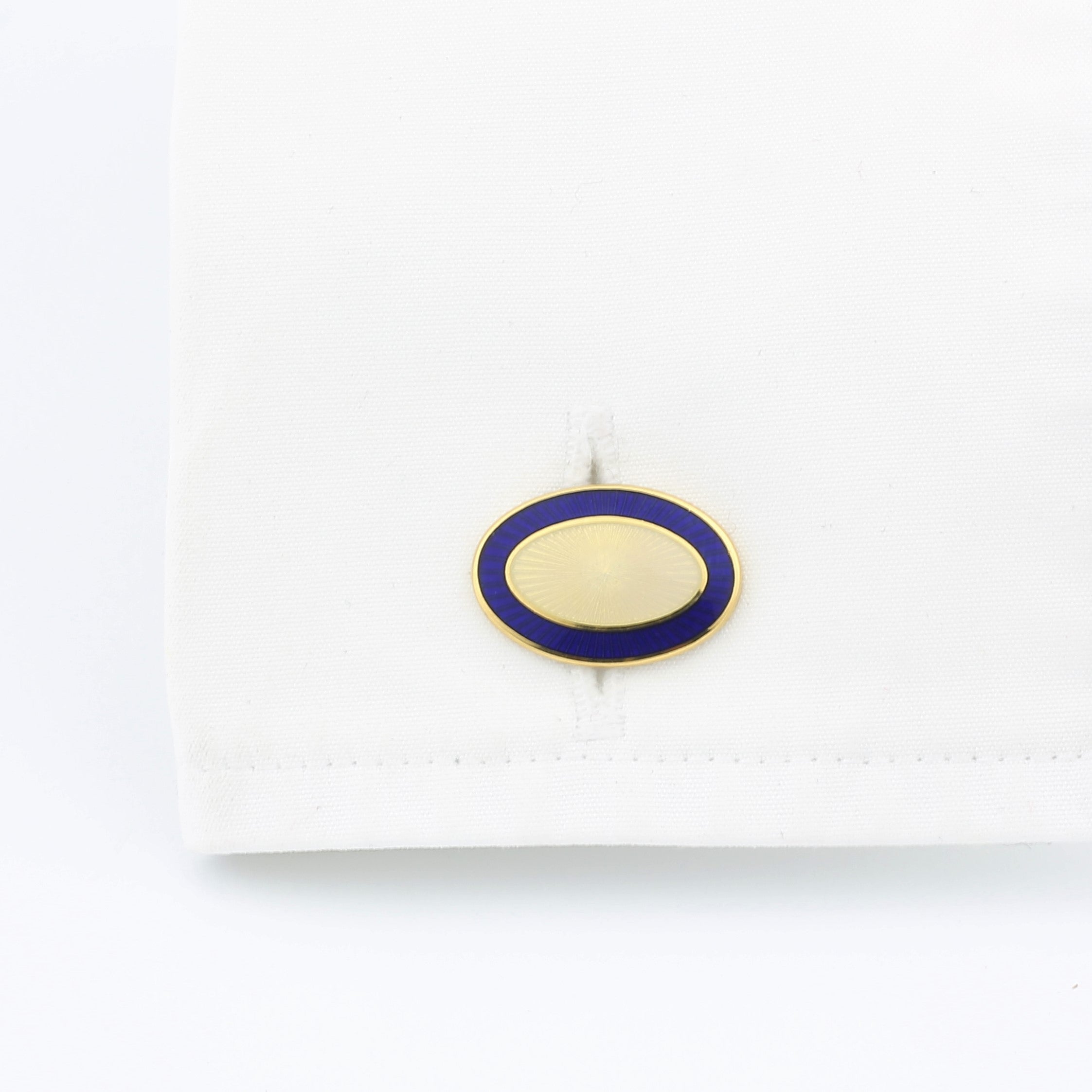 Double Oval Blue and cream cufflinks in 18k yellow gold in a cuff