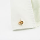 Classic knot cufflinks in 18k rose gold in a cuff