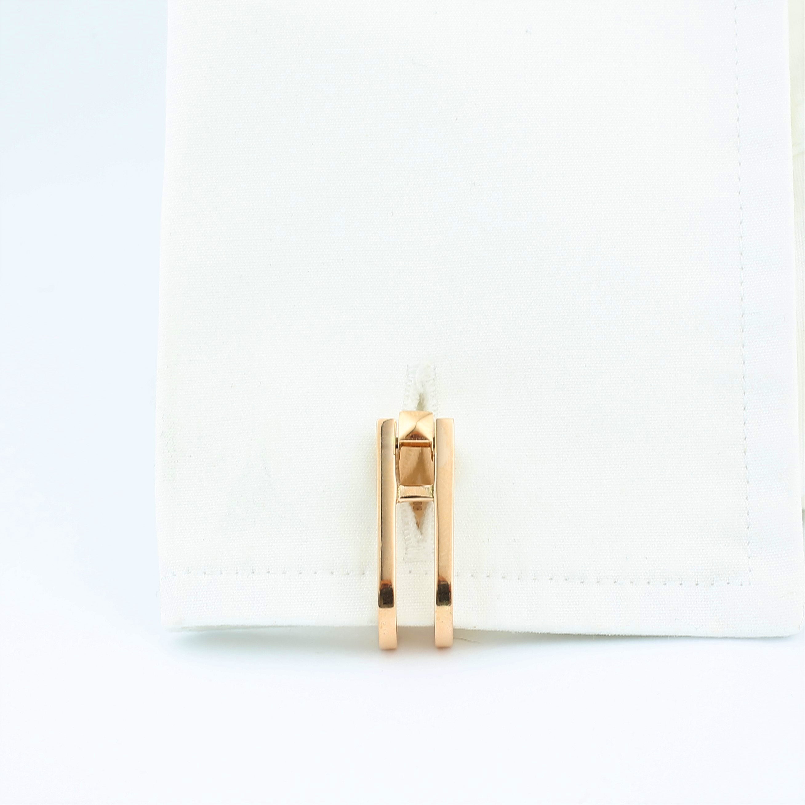 Double Stirrup cufflinks in 18k rose gold in a cuff