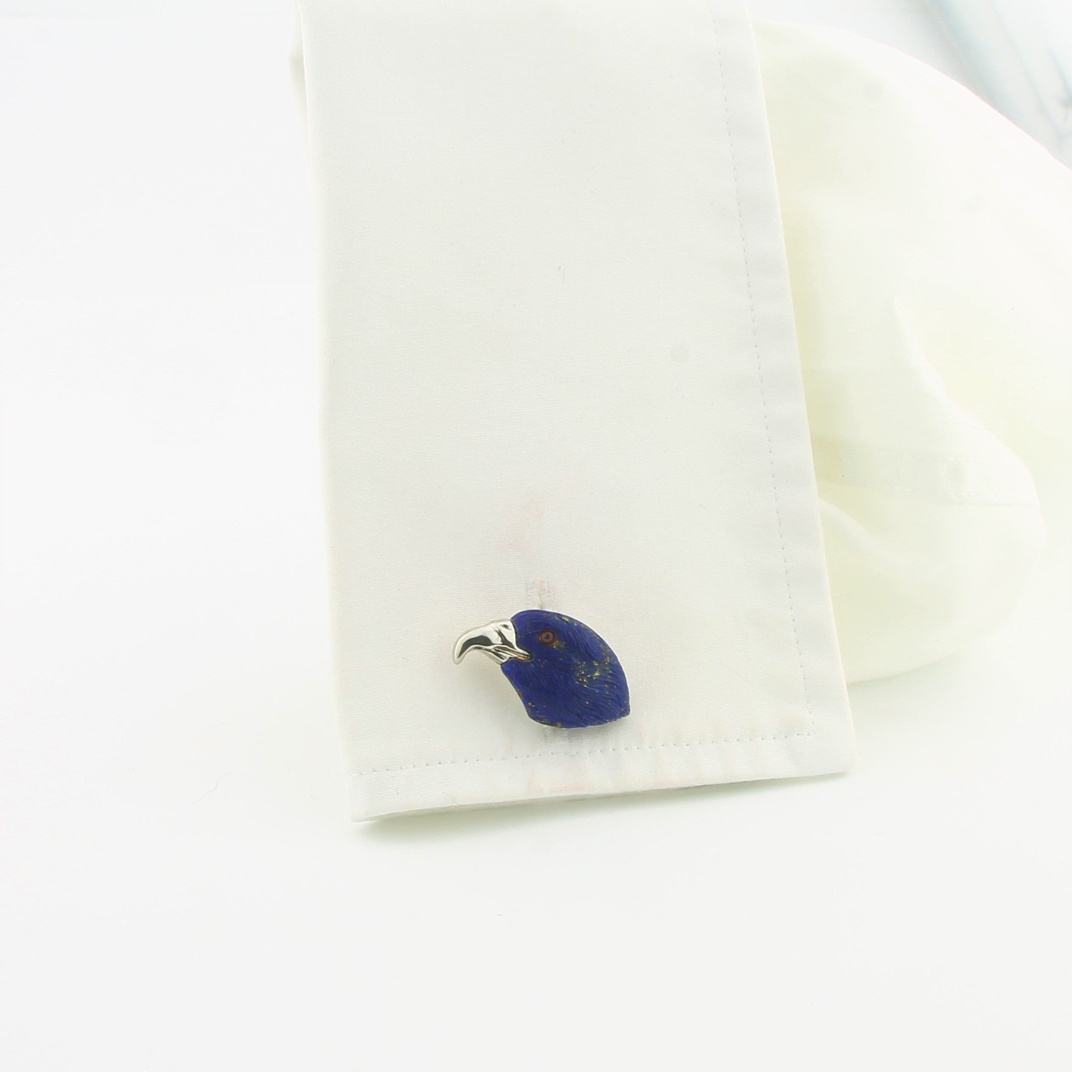 Eagle head cufflinks in lapis 18k white gold in a cuff