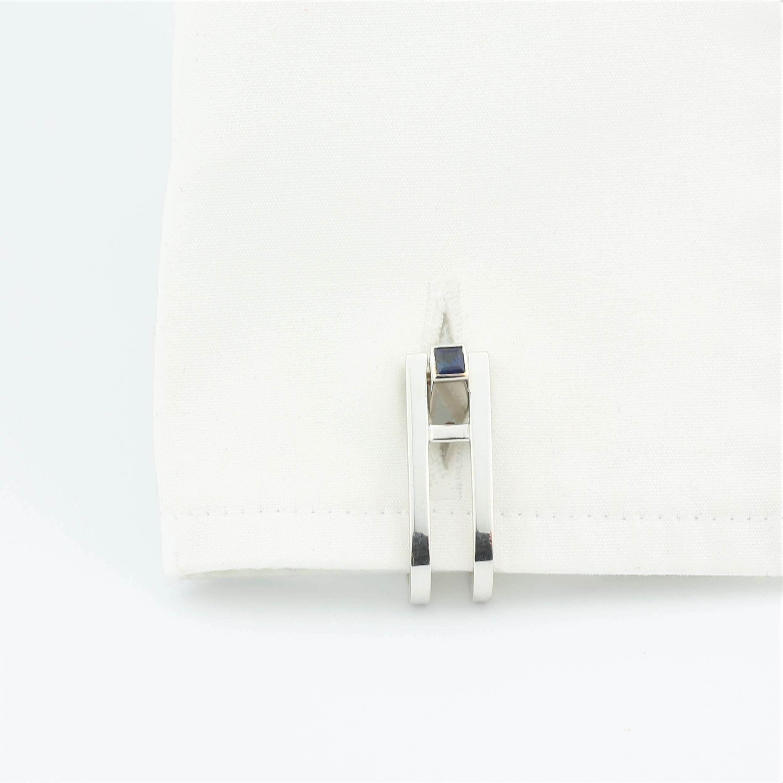 Double Stirrup cufflinks with sapphire terminal in 18k white gold in a cuff