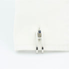 Double Stirrup cufflinks with sapphire terminal in 18k white gold in a cuff