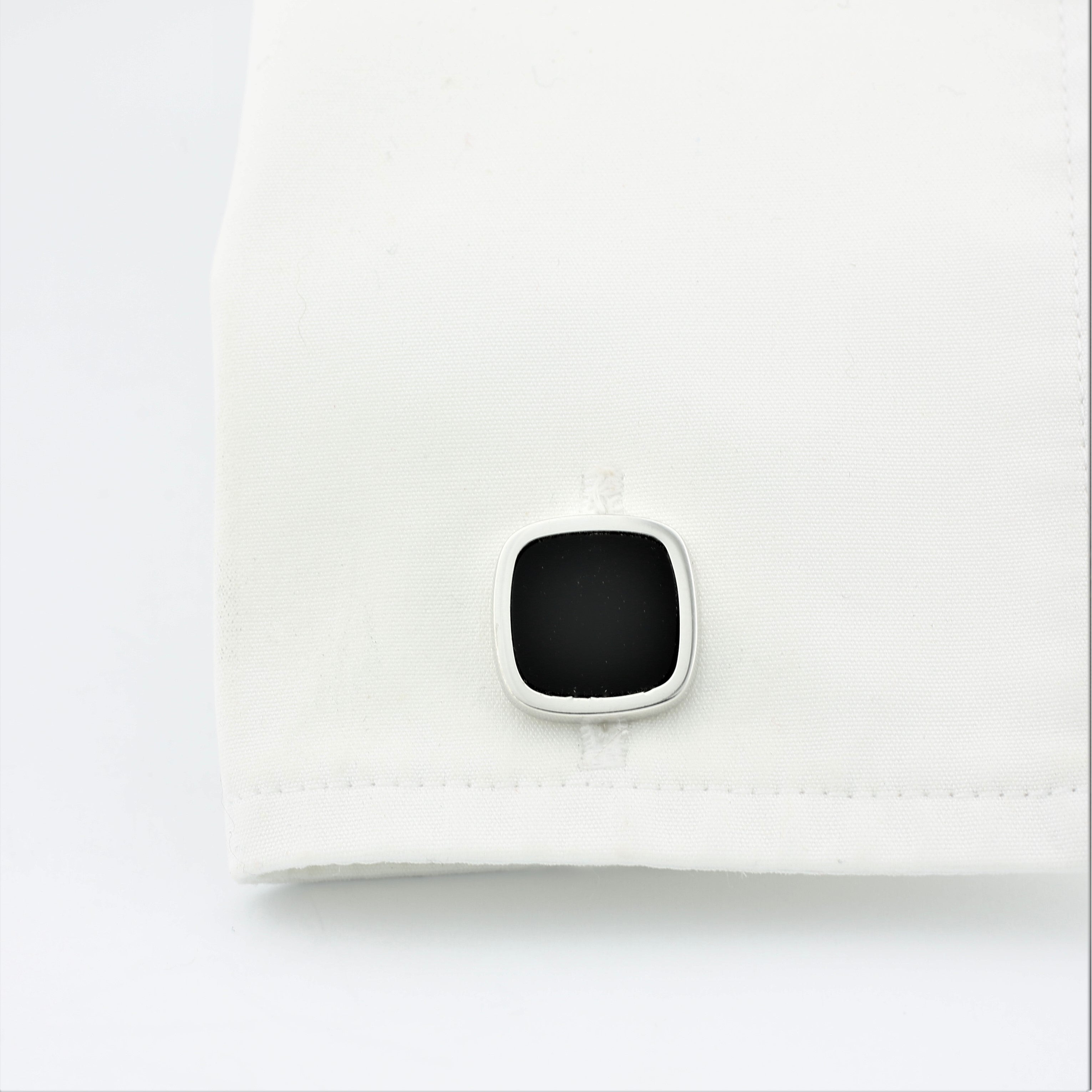 Onyx square cufflinks in silver in a cuff