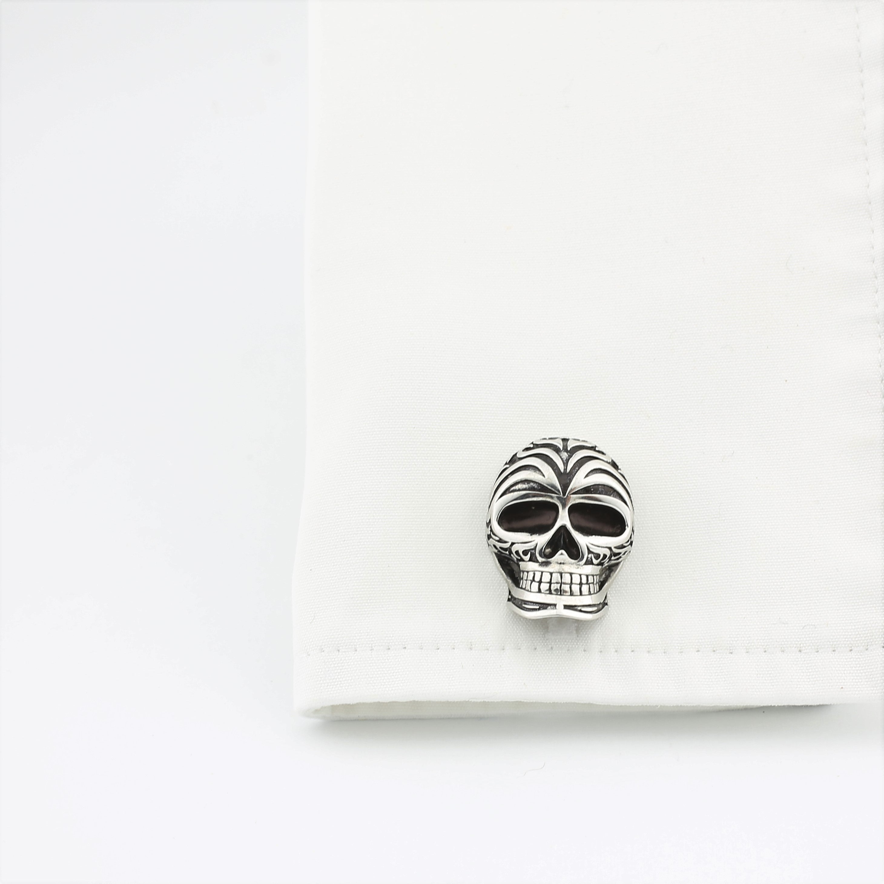 Skull cufflinks in silver and enamel in a cuff