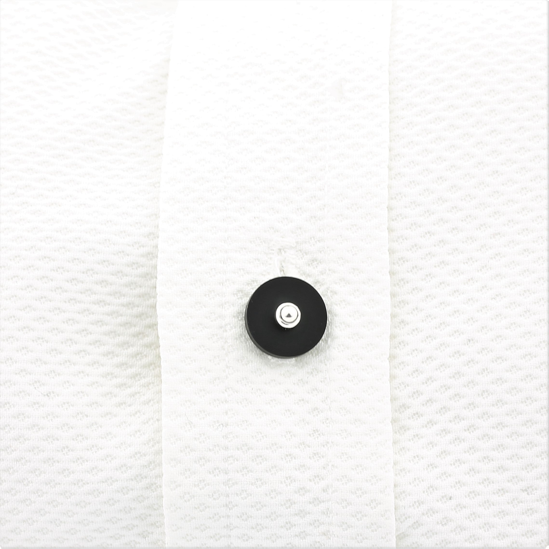 Onyx disc studs in 18k white gold in a shirt